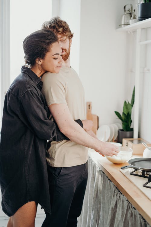 A couple cooking together in the kitchen